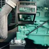 Volvo engine with radiator hose and guard inside the 112 kW generator