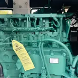 Volvo TAD750GE diesel engine with its inspection tag inside the 112 kW generator
