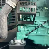 Volvo engine with radiator hose and guard inside the 200 kW generator