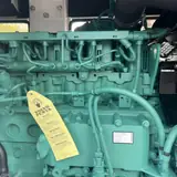 Volvo TAD754GE diesel engine with its inspection tag inside the 200 kW generator
