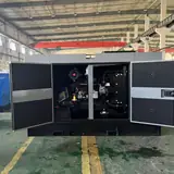 25 kW Yangdong generator enclosure with both service doors open showing the engine