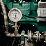 Gas inlet pressure gauge and flanged gas supply line on the 50 kW gas generator